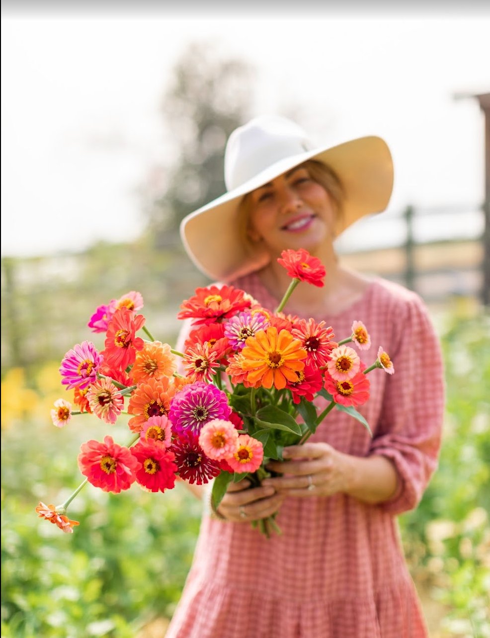 Jillian holding a bouquet of zinnias