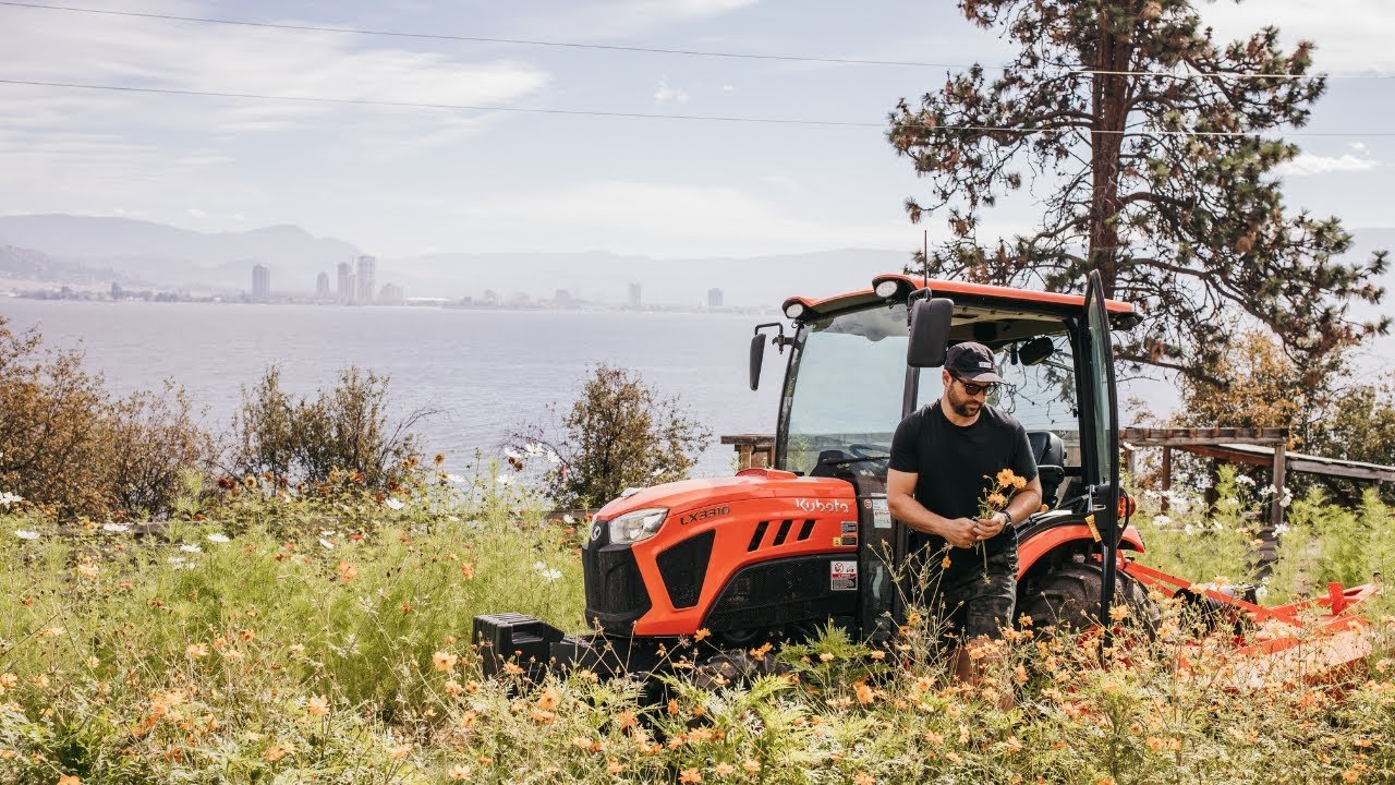 Justin on the tractor at the flower farm overlooking Okanagan Lake